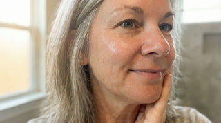 Woman over 50 using beef tallow balm for mature skin