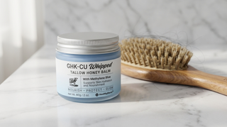 Copper peptide GHK-Cu tallow balm jar next to wooden hairbrush for hair growth routine