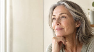 Woman in her fifties with natural skin texture showing marionette lines around the mouth